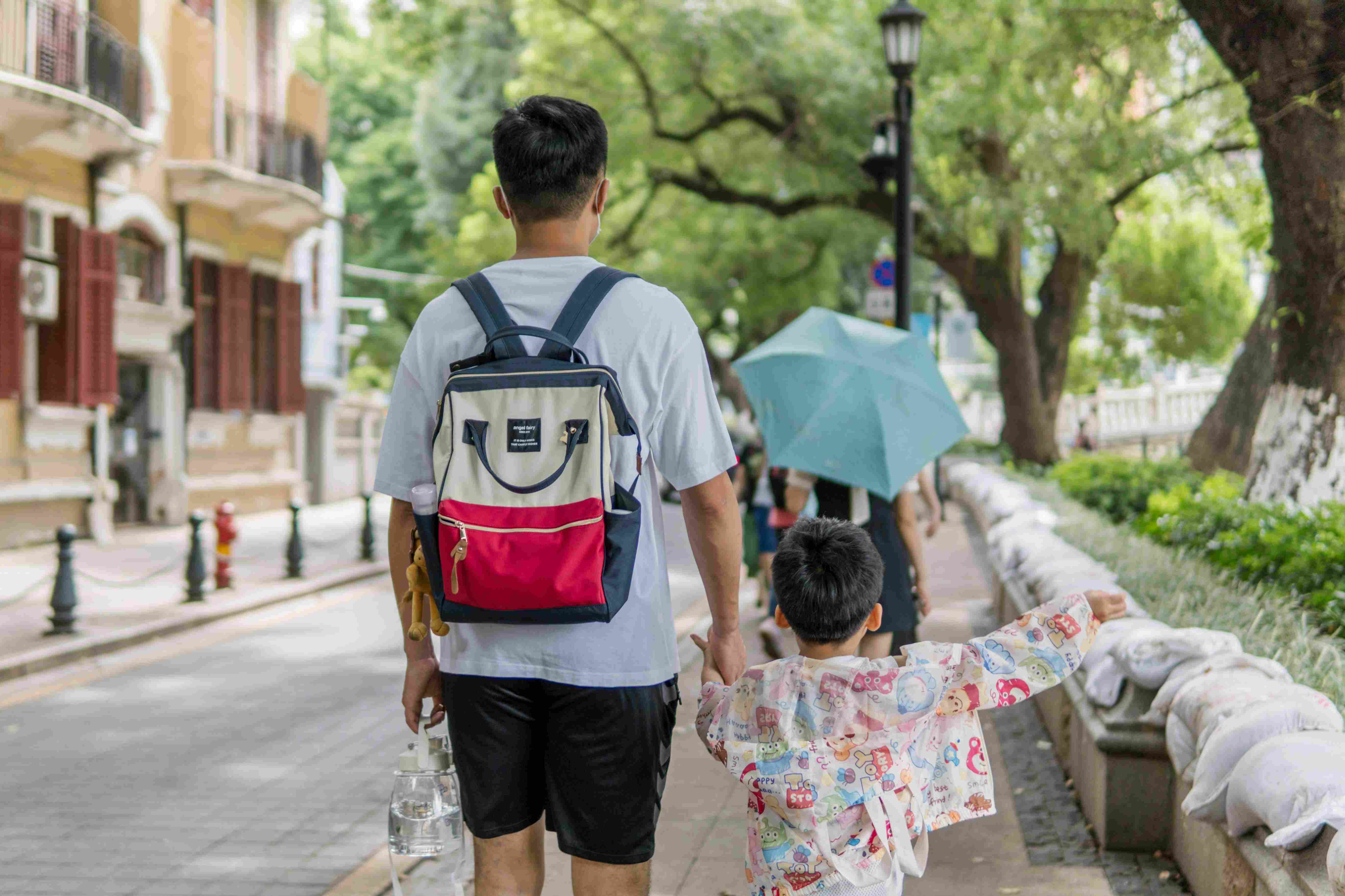 Parent and child exploring a neighborhood together